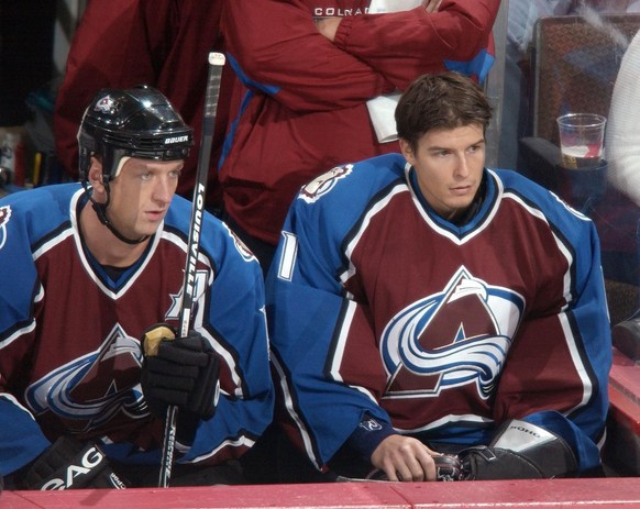 Colorado Avalanche goalie David Aebischer of Switzerland, right, joins defenseman Rob Blake in watching the action from the bench in the first period against the Buffalo Sabres in Denver, Sunday, Oct. ...