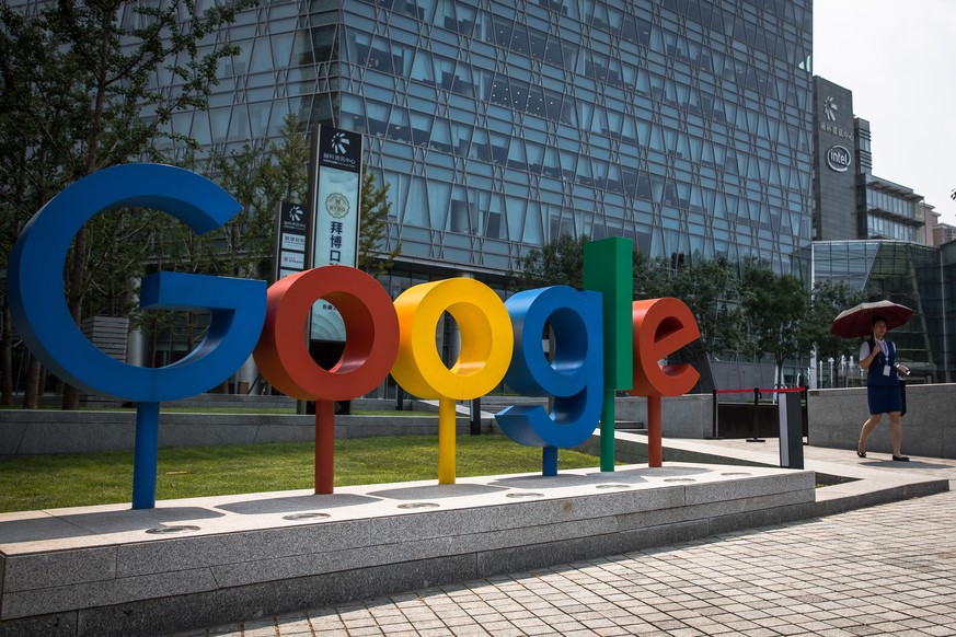 epa07586093 (FILE) - A Chinese woman walks next to a &#039;Google&#039; brand name and logo, near the Google office in Beijing, China, 03 August 2018 (reissued 20 May 2019). According to media reports ...
