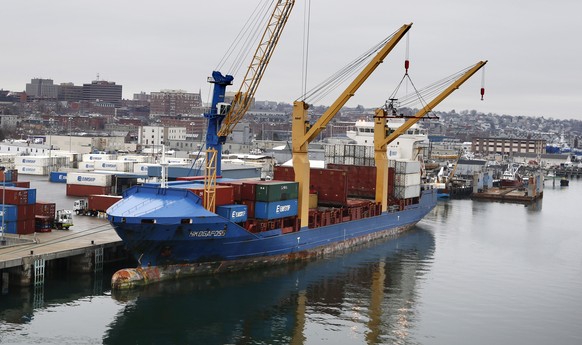 FILE - In this Friday, Jan. 29, 2016, file photo, an Icelandic cargo ship is loaded with containers in Portland, Maine. On Friday, Feb. 5, the Commerce Department reports on the U.S. trade gap for Dec ...
