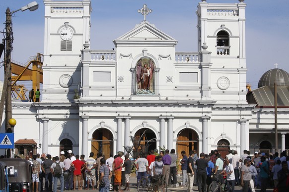 epa07520941 Sri Lankan people stand outside St. Anthony&#039;s Church in Kochchikade, Colombo, Sri Lanka, 22 April 2019. According to news reports, at least 290 people have been killed and over 500 in ...