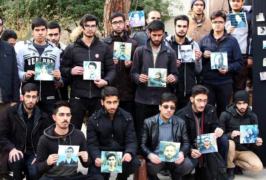 epa08127246 Iranian students hold pictures of victims of Ukraine airplane during a memorial ceremony for passengers of Ukraine airplane, at the Tehran university in Tehran, Iran, 14 January 2020. Medi ...