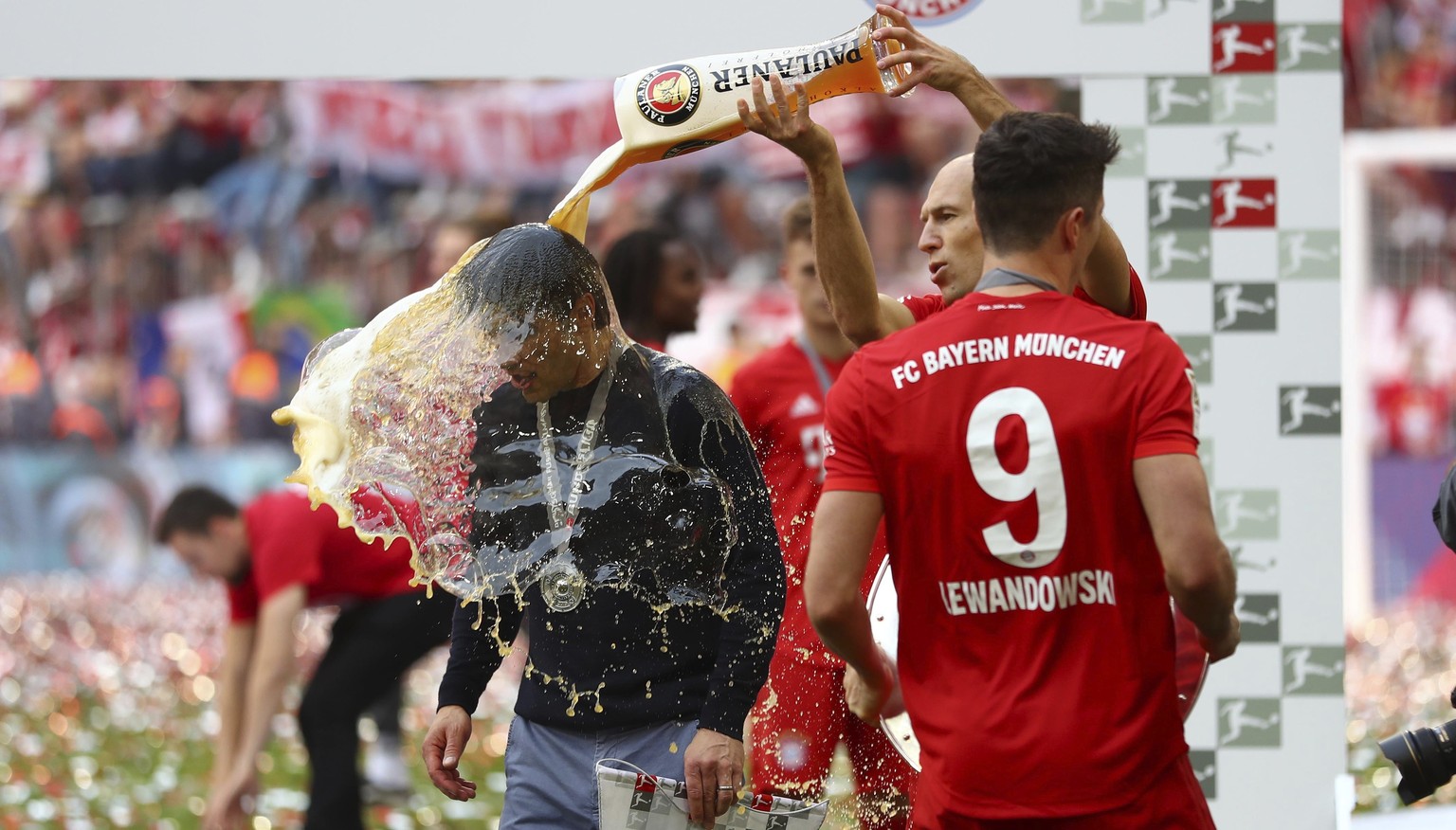 Bayern&#039;s Arjen Robben pours beer over coach Niko Kovac to celebrate Bayern&#039;s 7th straight Bundesliga title after the German Soccer Bundesliga match between FC Bayern Munich and Eintracht Fra ...