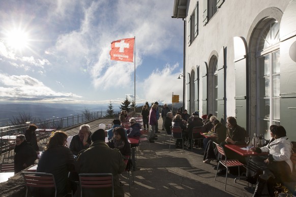 Touristen sitzen auf der Terrasse der Bergstation Weissenstein, am Samstag, 20. Dezember 2014. (KEYSTONE/Peter Klaunzer)