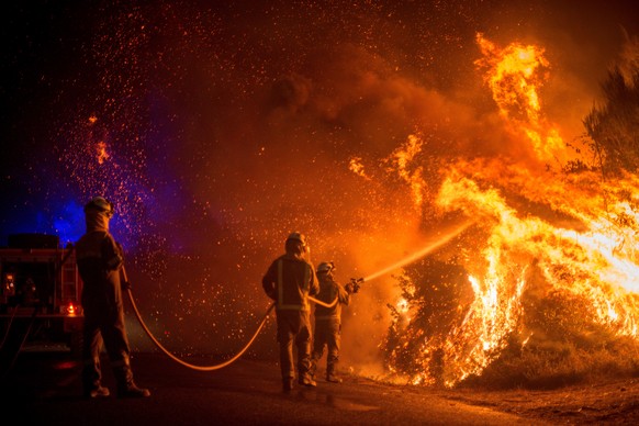 epa08667197 Firefighters try to extinguish one of the forest fires that originated in Cualedro, Ourense, northern Spain, 13 September 2020. Over 2,250 hectares have been burnt with more than eleven fo ...