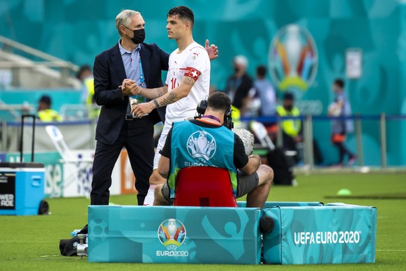 Switzerland&#039;s national soccer teams director Pierluigi Tami, left, reacts next to Switzerland&#039;s midfielder Granit Xhaka, right, during the Euro 2020 soccer tournament group A match between W ...