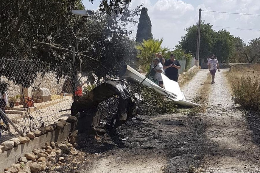 This photo provided by Incendios f.Baleares shows wreckage on a path near Inca in Palma de Mallorca, Spain, Sunday Aug. 25, 2019. Authorities in Mallorca say at least 5 people have died in a collision ...