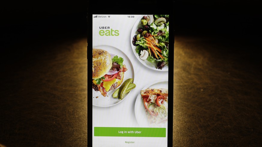This Tuesday, Feb. 20, 2018, photo so the Uber Eats app on an iPhone in Chicago. More fast-food companies have been offering delivery by teaming up with food ordering apps. (AP Photo/Charles Rex Arbog ...