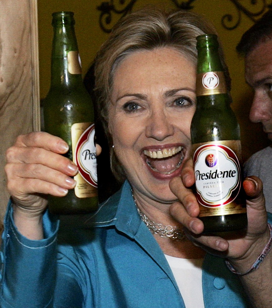 Democratic presidential hopeful, Sen. Hillary Rodham Clinton, D-N.Y., hoists a &quot;Presidente&quot; beer at Sabor Latino Restaurant &amp; Bar in San Juan, Puerto Rico Sunday, May 25, 2008. (AP Photo ...