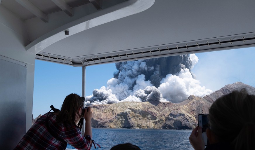 epa08056479 An image provided by visitor Michael Schade shows White Island (Whakaari) volcano, as it erupts, in the Bay of Plenty, New Zealand, 09 December 2019. According to police, at least five peo ...
