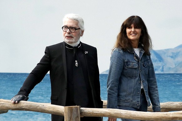 epa07380382 (FILE) - German designer Karl Lagerfeld (L) and Virginie Viard (R), fashion studio director and Lagerfeld&#039;s right-hand woman (R) watch as models present creations from his Spring/Summ ...
