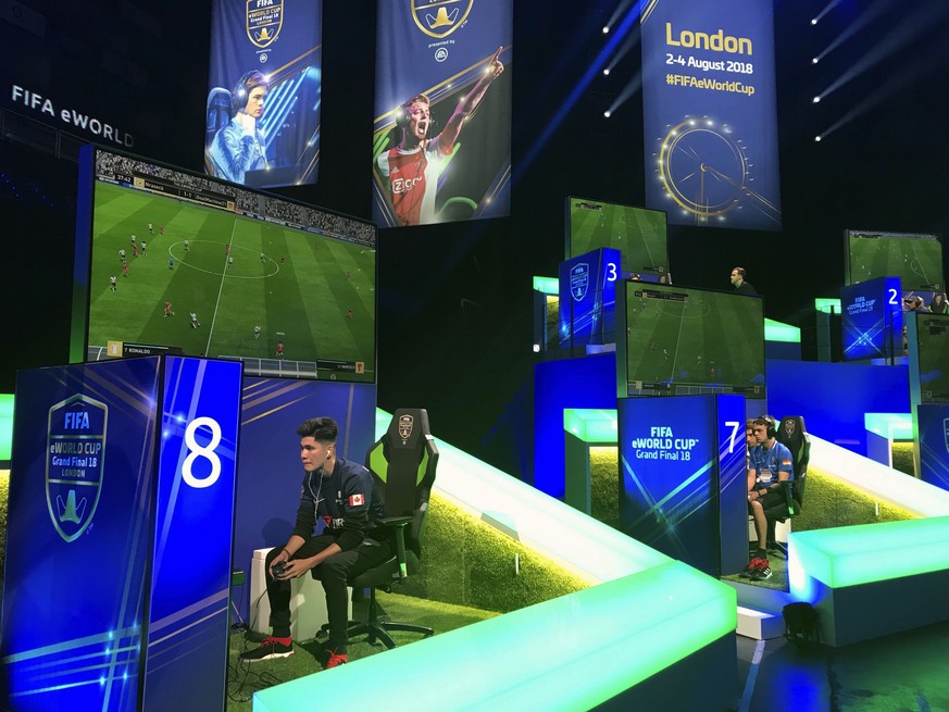 In this photo taken on Thursday, Aug. 2, 2018, competitors take part in the eWorld Cup grand final in London. Three weeks after the World Cup finished in Russia, the finals of the e-sports version are ...