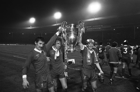Liverpool players, from left to right are, Terry McDermott, Phil Neal and Kenny Dalglish, parade the European Cup around Wembley Stadium in London on May 10, 1978, after defeating the Belgium champion ...