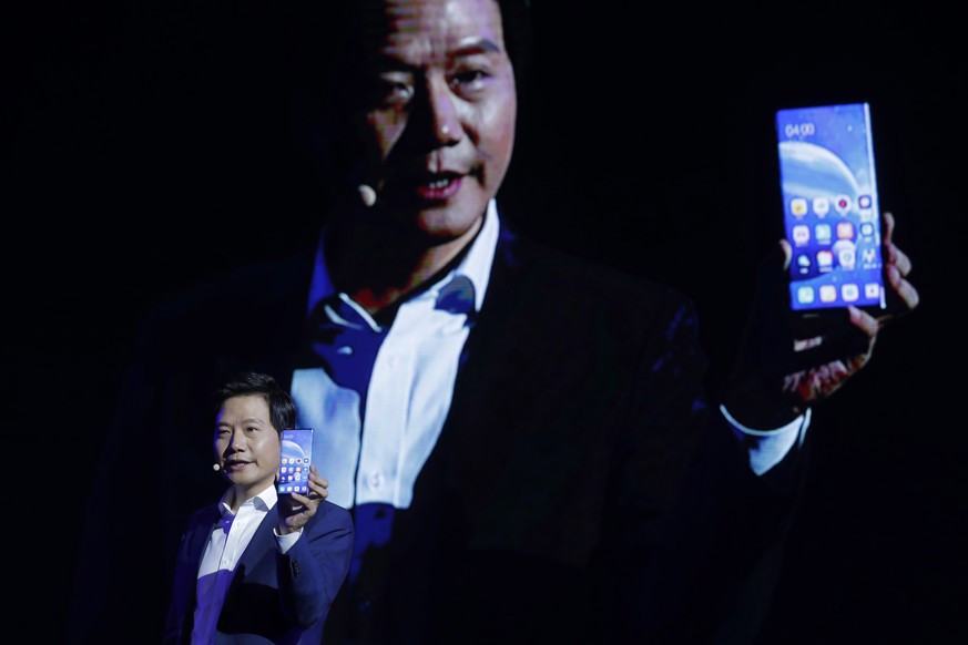 epa07865506 Lei Jun, Founder and CEO of Chinese mobile internet company Xiaomi Technology Co. Ltd., displays the Xiaomi MIX Alpha smartphone during the Xiaomi new 5G smartphone product launch ceremony ...