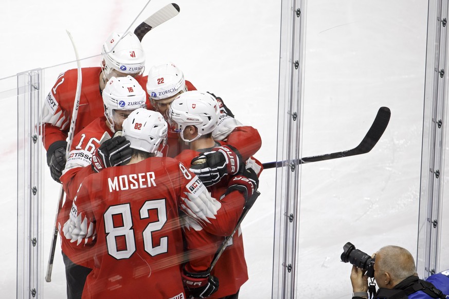 Switzerland&#039;s forward Enzo Corvi, right, celebrates his goal with teammates defender Mirco Mueller #41, defender Raphael Diaz #16, forward Simon Moser #82, and forward Nino Niederreiter #22, afte ...