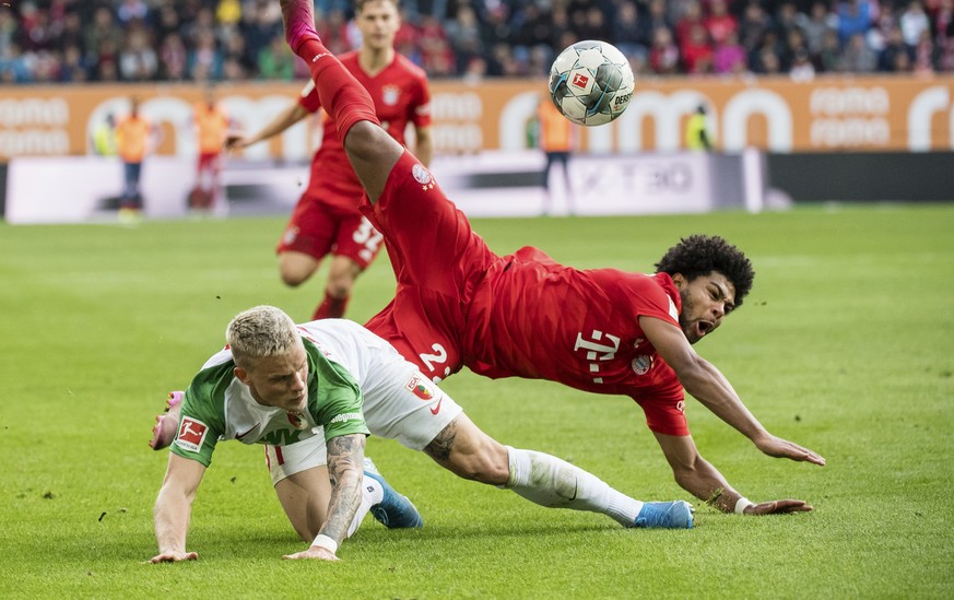 Augsburg&#039;s Philipp Max and Munich&#039;s Serge Gnabry challenge for the ball during a German Bundesliga soccer match between FC Augsburg and Bayern Munich in Augsburg, Germany, Saturday, Oct.19,  ...
