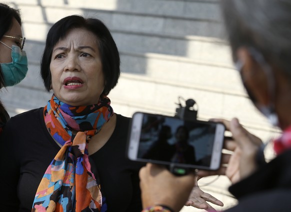 epa08947778 Former Revenue Department official Anchan Preelerd talks to the media as she arrives to hear the verdict in her trial over charges of lese majeste, at the Criminal Court in Bangkok, Thaila ...
