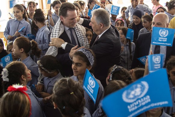 epa07837489 Commissioner-General of the United Nations Relief and Works Agency for Palestine Refugees in the Near East (UNRWA) Pierre Krahenbuhl (C-L) receives a Palestinian &#039;Koufieh&#039; from P ...