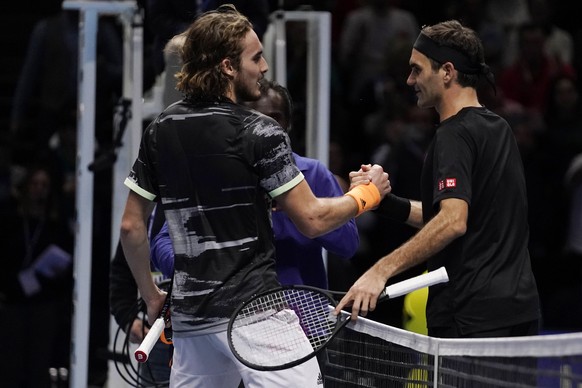 epa08002027 Stefanos Tsitsipas of Greece and Roger Federer of Switzerland embrace after their mens semi final match at the ATP World Tour Finals tennis tournament in London, Britain, 16 November 2019. ...