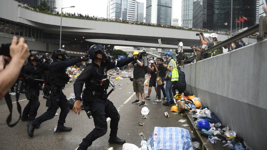 epa07643239 Police react on protesters during a rally against an extradition bill outside the Legislative Council in Hong Kong, China, 12 June 2019. The bill, scheduled for a second reading on 12 June ...
