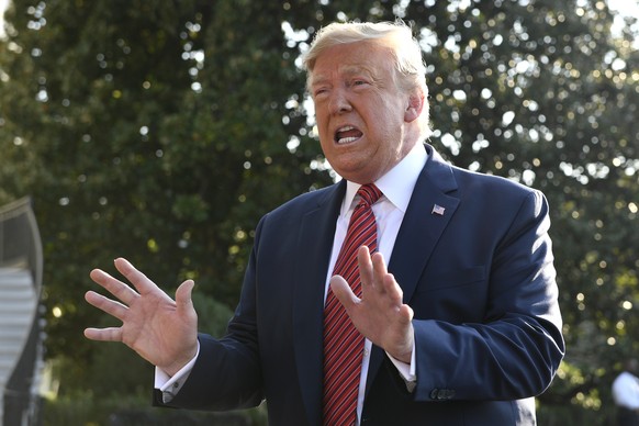 President Donald Trump talks with reporters on the South Lawn of the White House in Washington, Sunday, Sept. 22, 2019, as he prepares to board Marine One for the short trip to Andrews Air Force Base. ...