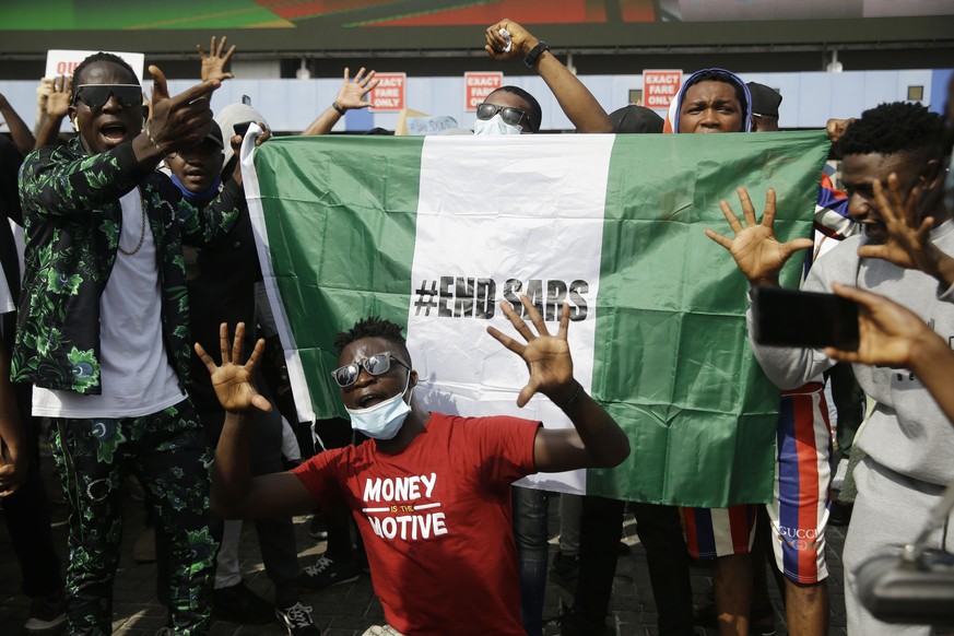 People demonstrate on the street to protest against police brutality in Lagos, Nigeria, Tuesday Oct. 13, 2020. Crowds protesting against police brutality in Nigeria have taken to the streets for a six ...