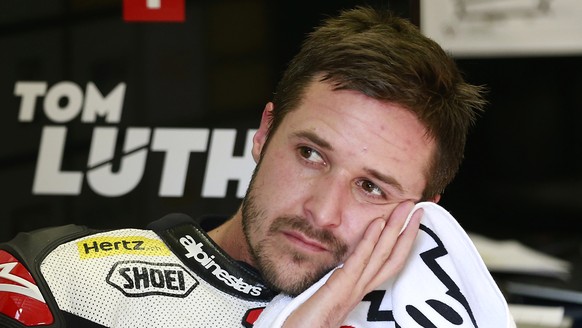 Moto2 rider Thomas Luthi of Switzerland waits for the qualifying session for the MotoGP Japanese Motorcycle Grand Prix at the Twin Ring Motegi circuit in Motegi, north of Tokyo, Saturday, Oct. 15, 201 ...