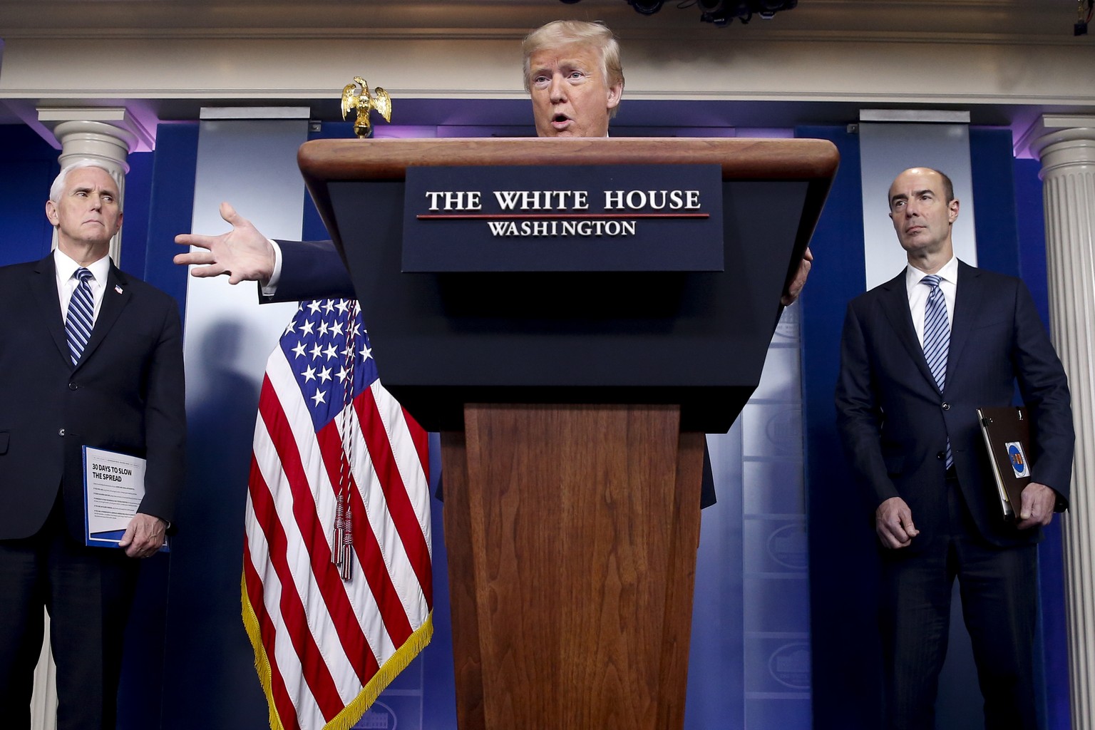 President Donald Trump, accompanied by Vice President Mike Pence, left, and Labor Secretary Eugene Scalia, right, speaks about the coronavirus in the James Brady Press Briefing Room of the White House ...