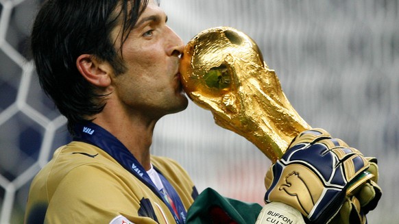 Italy&#039;s goal keeper Gianluigi Buffon kisses the World Cup trophy after the final of the soccer World Cup between Italy and France in the Olympic Stadium in Berlin, Sunday, July 9, 2006. Italy bea ...
