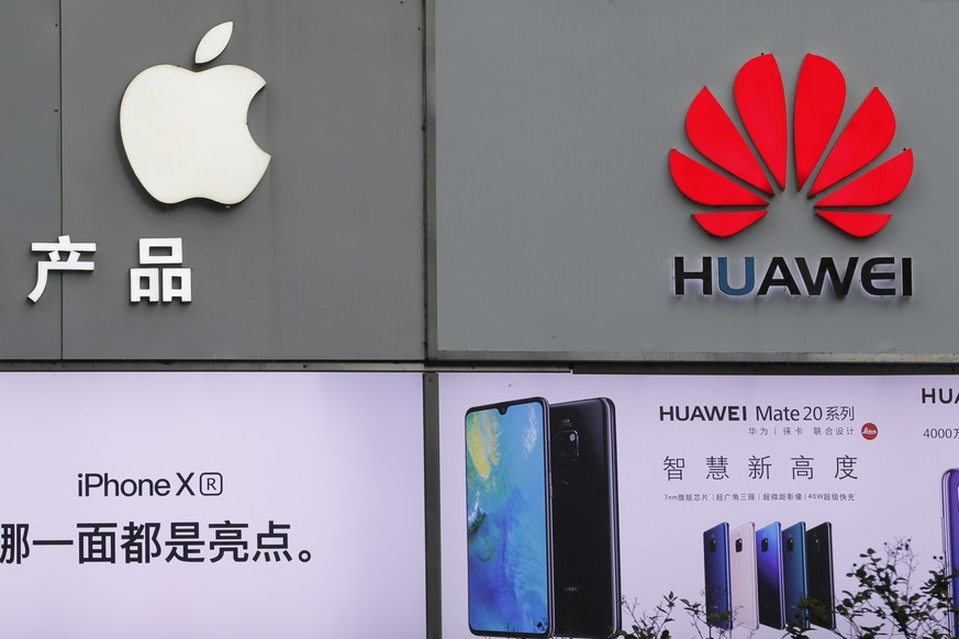 Logos of Apple and Huawei are displayed outside mobile phone retail shop in Shenzhen, China&#039;s Guangdong province, Thursday, March 7, 2019. Chinese tech giant Huawei is challenging a U.S. law that ...