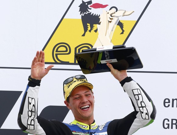 Winner Suter Moto2 rider Dominique Aegerter of Switzerland celebrates with the trophy during the German Grand Prix at the Sachsenring circuit in the eastern German town of Hohenstein-Ernstthal July 13 ...