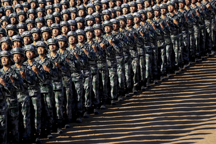 In this photo released by China&#039;s Xinhua News Agency, Chinese People&#039;s Liberation Army (PLA) troops march in formation Sunday, July 30, 2017 as they arrive for a military parade to commemora ...