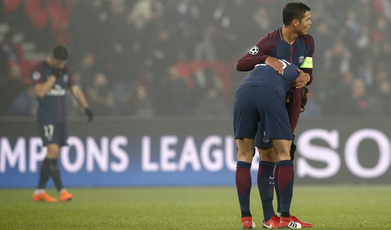 Captain PSG&#039;s Thiago Silva, right, hugs PSG&#039;s Adrien Rabiot after the Champions League round of sixteen second leg soccer match between Paris St. Germain and Real Madrid at the Parc des Prin ...