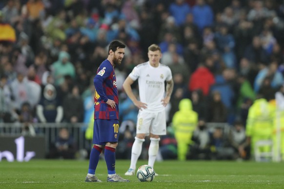 Barcelona&#039;s Lionel Messi, left, reacts after Real Madrid&#039;s Mariano Diaz scored his side&#039;s second goal during the Spanish La Liga soccer match between Real Madrid and Barcelona at the Sa ...