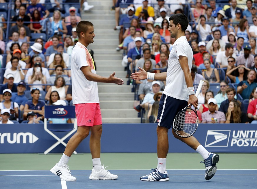 Mikhail Youzhny, of Russia, left, shakes Novak Djokovic&#039;s hand upon retiring from their match in the first set during the third round of the U.S. Open tennis tournament, Friday, Sept. 2, 2016, in ...