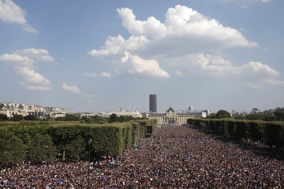 Thousands of French soccer team supporters gather on the Champ de Mars as they watch of the World Cup final between France and Croatia, Sunday, July 15, 2018 in Paris. (AP Photo/Laurent Cipriani)