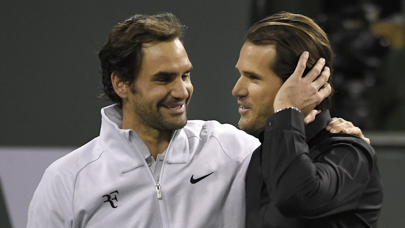 Roger Federer, left, of Switzerland, greets Tommy Haas, of Germany, after Haas announced his retirement following Federer&#039;s quarterfinal match against Chung Hyeon at the BNP Paribas Open tennis t ...