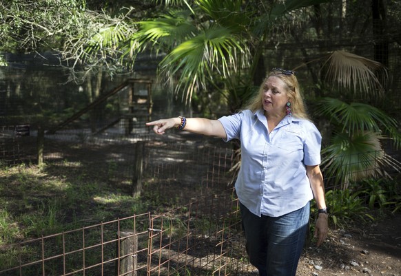 FILE - In this July 20, 2017, file photo, Carole Baskin, founder of Big Cat Rescue, walks the property near Tampa, Fla. A federal judge in Oklahoma has awarded ownership of the zoo made famous in Netf ...