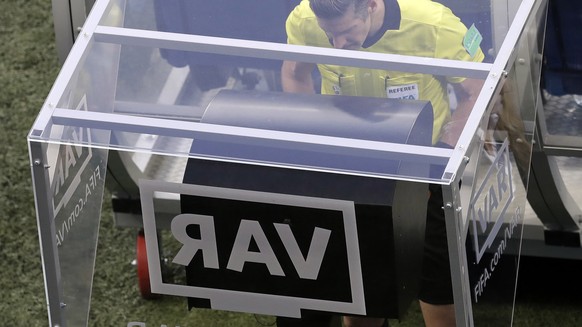 FILE - In this Friday, June 22, 2018 file photo, eeferee Matt Conger from New Zealand watches the Video Assistant Referee system, known as VAR during the group D match between Nigeria and Iceland at t ...