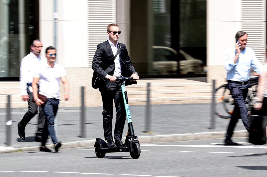 epa07672467 A man uses an e-scooter in downtown Frankfurt Main, Germany, 25 June 2019. &#039;Tier Mobility&#039; company starts the business of renting e-scooters since last weekend. The company is al ...