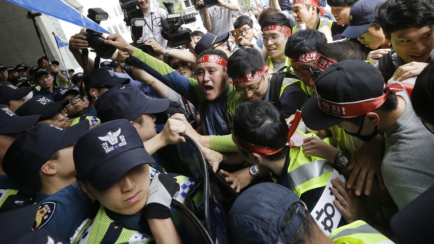 Workers from port-related organizations in Busan city scuffle with police officers during a rally to plead with the government and creditors of Hanjin Shipping Co. to map out measures to save the trou ...