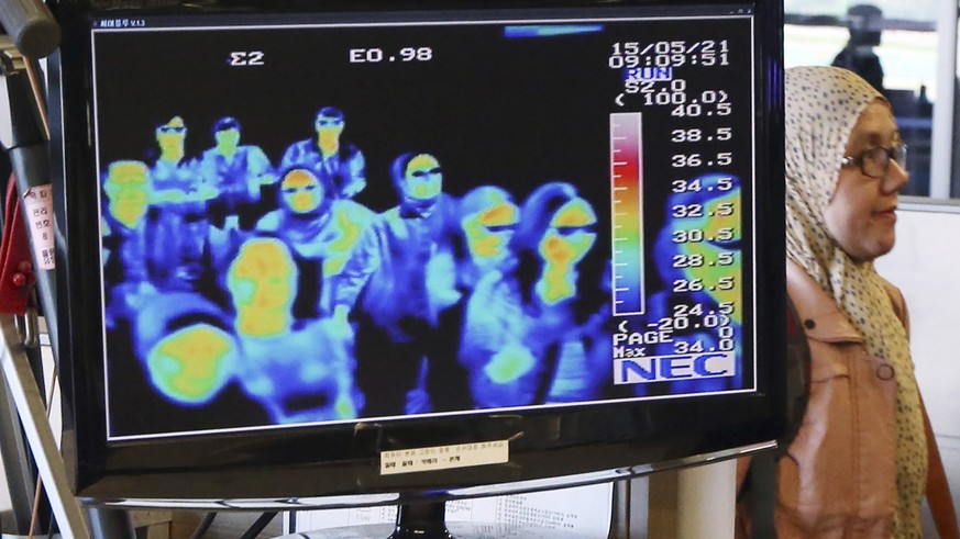 FILE - In this May 21, 2015, file photo, a thermal camera monitor shows the body temperature of passengers arriving from overseas against possible MERS, Middle East Respiratory Syndrome, virus at the  ...