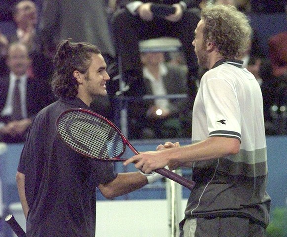 Switzerland&#039;s tennis player Roger Federer, left, shakes hand with his compatriot Marc Rosset, Sunday, February 13, 2000, in Marseille, southern France, after being defeated during the final of th ...