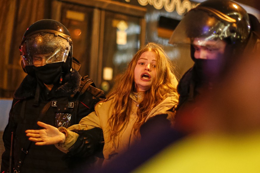 Riot police detain a young woman during a protest against the jailing of opposition leader Alexei Navalny in Pushkin square in Moscow, Russia, Saturday, Jan. 23, 2021. Russian police arrested more tha ...