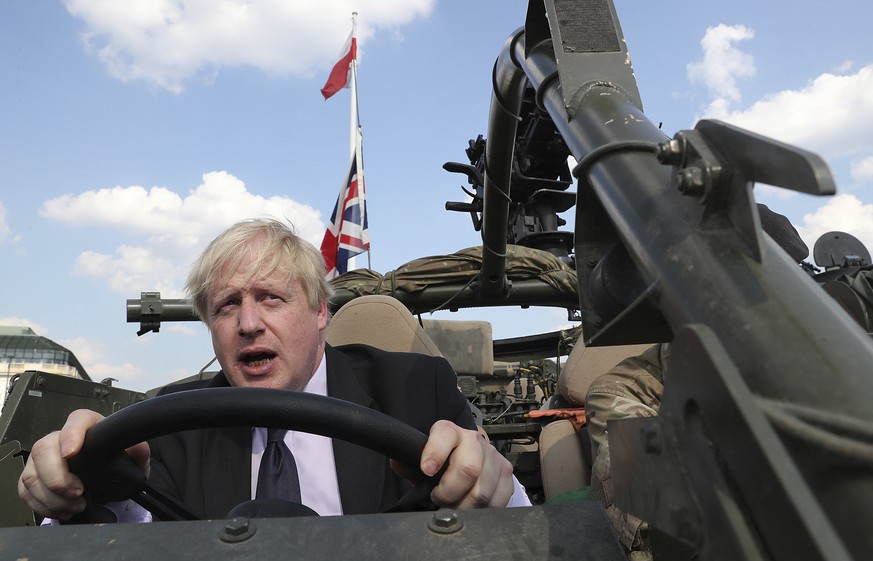 FILE - In this Thursday, June 21, 2018 file photo Britain&#039;s Foreign Secretary Boris Johnson talks to a British armed forces serviceman based in Orzysz, in northeastern Poland, during a ceremony a ...