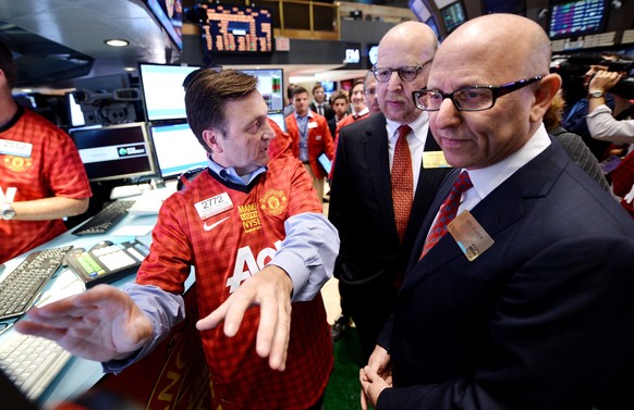 epa09144572 (FILE) - Joel (R) and Avram Glazer (C), owners of the Manchester United, talk with Thomas Facchine (L) of Getco Securities during the initial public offering of shares of Manchester United ...