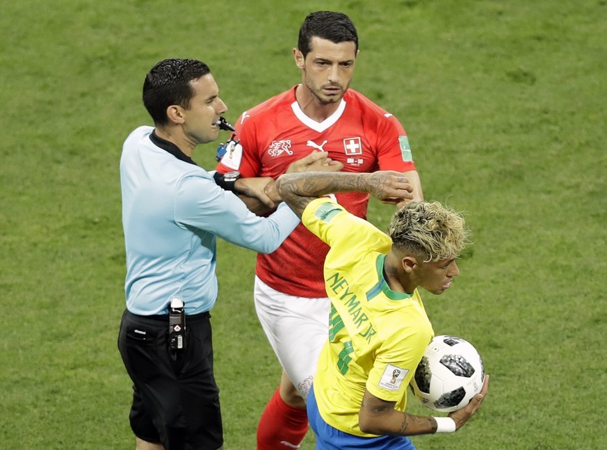 Mexican referee Cesar Arturo Ramos, left, tries to stop Switzerland&#039;s Blerim Dzemaili, center, as he tries to take the ball from Brazil&#039;s Neymar during the group E match between Brazil and S ...