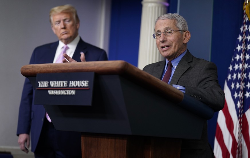 President Donald Trump listens as Director of the National Institute of Allergy and Infectious Diseases Dr. Anthony Fauci speaks during a coronavirus task force briefing at the White House, Friday, Ap ...