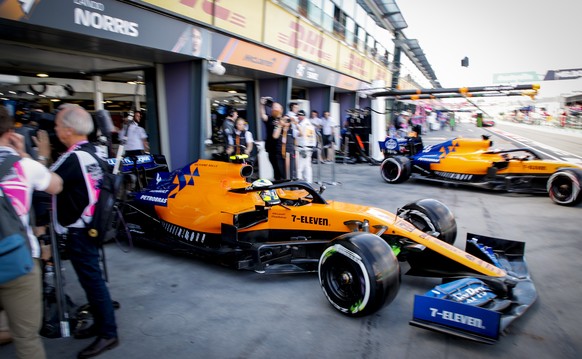 epa07438114 British Formula One driver Lando Norris (L) of McLaren and Spanish Formula One driver Carlos Sainz of McLaren exit the garage during the first practice session ahead of the 2019 Formula On ...