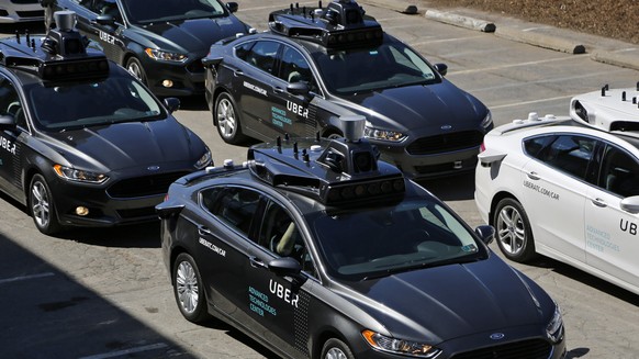 FILE- This Sept. 12, 2016, file photo, shows group of self driving Uber vehicles position themselves to take journalists on rides during a media preview at Uber&#039;s Advanced Technologies Center in  ...
