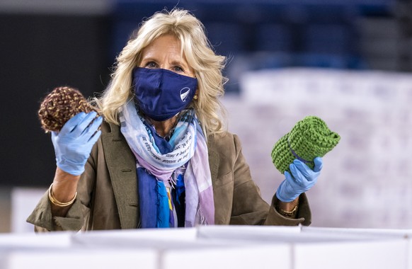 Jill Biden, wife of President-elect Joe Bien, helps to prepare care packages for American troops deployed overseas during the holidays, at the DC Armory in Washington, Thursday, Dec. 10, 2020. (AP Pho ...